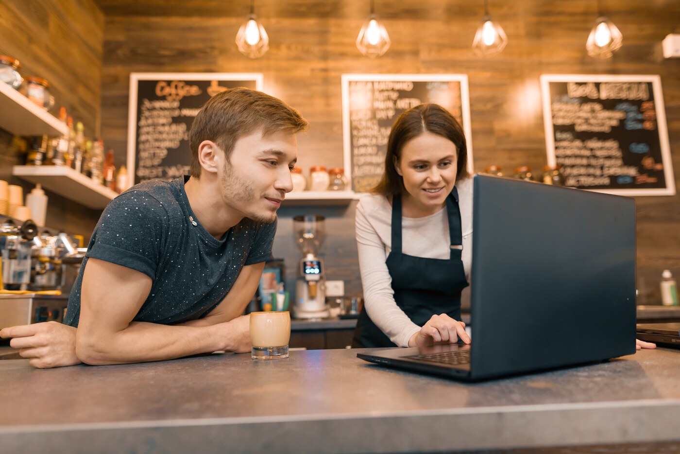 Cafe team reviewing training together on a laptop